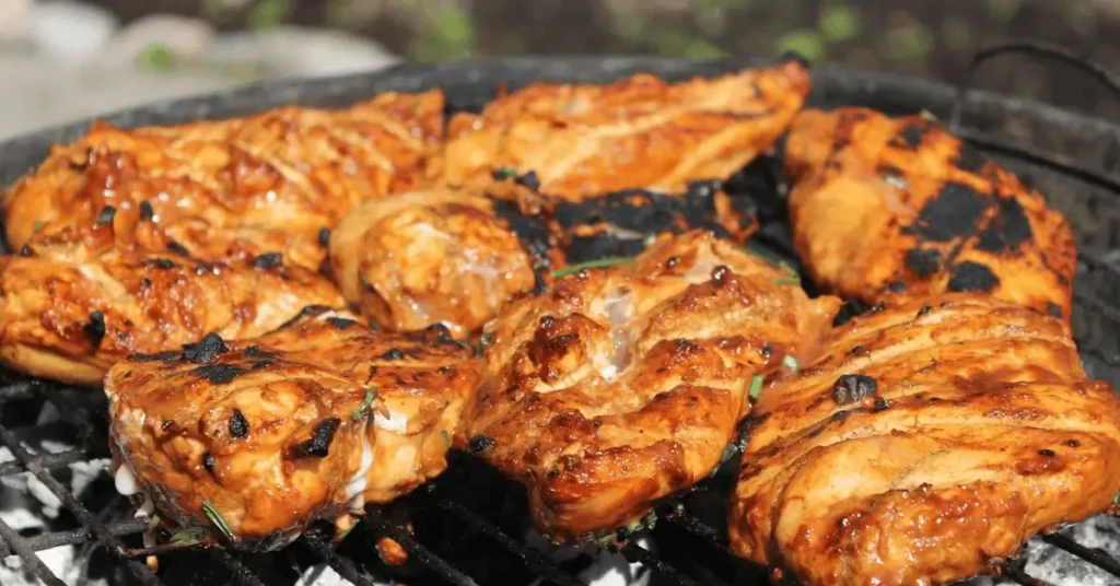 Juicy, marinated chicken breasts sizzling on a hot grill with perfectly charred edges, ready to be the star ingredient in a flavorful grilled chicken wrap recipe.