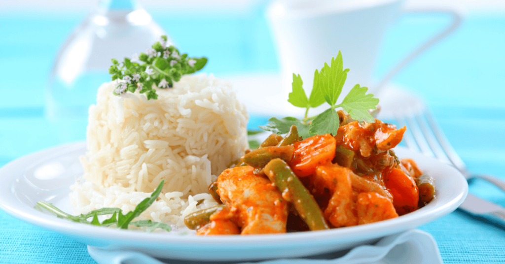 A vibrant plate featuring rice recipe with Korean chicken, served with perfectly steamed rice and colorful vegetables, garnished with fresh herbs.