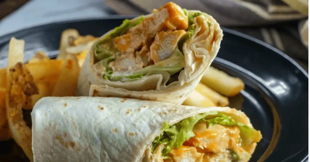 A fresh and vibrant chicken salad wrap with leafy greens and colorful vegetables, perfect for a healthy meal.